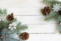 Christmas frame with fir branches, pine, snowflackes on a white wood background Royalty Free Stock Photo