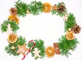 Christmas frame with fir tree branches, oranges, gingerbread cookies Royalty Free Stock Photo