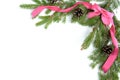 Christmas frame of fresh fir branches, cones and ribbon bow isolated on white background Royalty Free Stock Photo