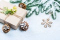 Christmas frame with gift, the branches of the Christmas tree and wooden decorations on snow background Royalty Free Stock Photo