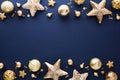 Christmas frame of golden decorations on dark blue background. Gold baubles, stars, confetti. Xmas greeting card template, banner Royalty Free Stock Photo