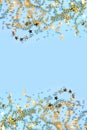 Christmas frame with golden glitter confetti stars on blue. Flat lay. View from above. Xmas vertical border Royalty Free Stock Photo