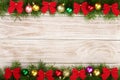 Christmas frame made of fir branches decorated with balls and bows on a light wooden background Royalty Free Stock Photo