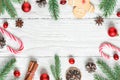 Christmas frame made of fir branches, decorations, berries, candy, christmas food and pine cones. flat lay Royalty Free Stock Photo