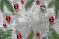 Christmas frame made of fir branches, decorations, berries and pine cones on concrete background Royalty Free Stock Photo