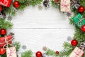 Christmas frame made of fir branches, festive decorations, gift boxes and pine cones Royalty Free Stock Photo