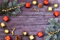 Christmas frame made of fir branches, holiday decorations and pine cones on a wooden table Royalty Free Stock Photo