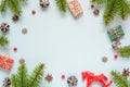 Christmas frame made of fir branches, red berries, gift boxes, retro toy and pine cones Royalty Free Stock Photo