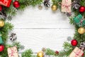 Christmas frame made of fir branches, red and golden decorations, gift boxes and pine cones Royalty Free Stock Photo