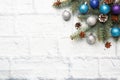 Christmas frame made of fir, Christmas tree decorations in silver and blue on a light brick background. Copy space. Flat lay Royalty Free Stock Photo