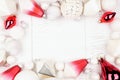 Christmas frame of modern red and white ornaments, above view on a white wood background Royalty Free Stock Photo