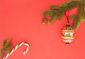 Christmas frame on red background. Green fir branches, Xmas decoration and candy cane. Top view, flat lay. Copy space Royalty Free Stock Photo