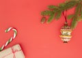 Christmas frame on red background. Green fir branches, Xmas gifts, decorations and candy canes. Top view, flat lay. Copy Royalty Free Stock Photo