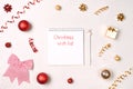 Christmas frame with red, golden holiday decorations and notebook with wish list. New year planning concept. Flat lay