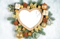 Christmas frame in the shape of a heart is surrounded by branches of a New Year tree Christmas decorations, Isolated on white Royalty Free Stock Photo