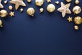 Christmas frame top border made of gold baubles and stars on dark blue background. Greeting card template with luxury Xmas Royalty Free Stock Photo