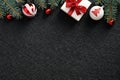 Christmas frame top border made of red and white balls, elegant gift box with ribbon bow, fir branches. Black Xmas background, Royalty Free Stock Photo