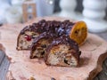 Christmas fruit cake, pudding on wooden plate with ginger cookies and chokolate-nut glaze. Copy space. Close up Royalty Free Stock Photo