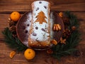 Christmas fruitcake powdered sugar tangerine fir tree festive decoration wooden background flat lay. Stollen cake loaf Royalty Free Stock Photo