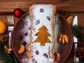 Christmas fruitcake powdered sugar tangerine fir tree festive decoration wooden background flat lay. Stollen cake loaf Royalty Free Stock Photo