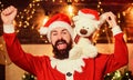 Christmas fun. new year gifts. christmas decoration. santa claus hold teddy bear. merry christmas. man santa hat. winter Royalty Free Stock Photo