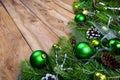 Christmas garland with green baubles on the rustic wooden background, copy space Royalty Free Stock Photo