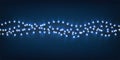 Christmas garland of lights on blue background Royalty Free Stock Photo