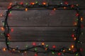 Christmas garland lights on grey background, copy space. Royalty Free Stock Photo