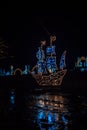 Christmas garlands installations .shining ship made of garlands in the dark.Shimmering street scenery on night streets