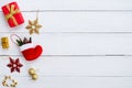 Christmas gif boxes, snow flake, red sock, christmas ball and candy cane on white wooden board.