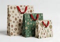 Christmas gift bags in different sizes with red handles Royalty Free Stock Photo