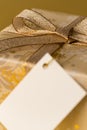 Christmas gift with blank tag gold ribbon Royalty Free Stock Photo