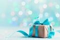 Christmas gift box against blue bokeh background. Holiday greeting card. Royalty Free Stock Photo