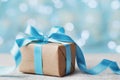 Christmas gift box against blue bokeh background. Holiday greeting card. Royalty Free Stock Photo