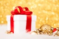 Christmas gift box against gold bokeh background