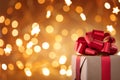 Christmas gift box against golden lights and bokeh background. Holiday greeting card Royalty Free Stock Photo