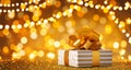 Christmas gift box against golden lights and bokeh background. Holiday greeting card Royalty Free Stock Photo