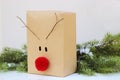 Christmas gift box decorated with a red reindeer nose and antlers Royalty Free Stock Photo