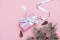 Christmas gift box with decoration on pink background. Top view