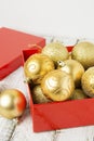 Christmas Gift Box with golden baubles and Decorations. White rustic wooden table Royalty Free Stock Photo