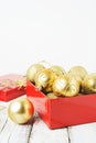 Christmas Gift Box with golden baubles and Decorations. White rustic wooden table Royalty Free Stock Photo