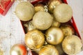 Christmas Gift Box with golden baubles and Decorations. White rustic wooden table Royalty Free Stock Photo