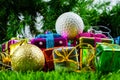 Christmas gift box and golf ball on grass Royalty Free Stock Photo