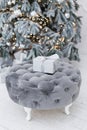 Christmas gift box on grey pouf Royalty Free Stock Photo