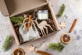 Christmas gift box with hugge items textile pouch, candle, wooden toy for tree. Care package concept