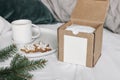 Christmas gift box mockup scene. Cup of coffee, gingerbread cookies and spruce tree branches on ceramic plate. Holiday