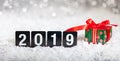 Christmas gift box and new year 2019, on snow, abstract bokeh lights background Royalty Free Stock Photo