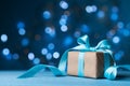 Christmas Gift Box Or Present With Bow Ribbon On Magic Blue Bokeh Background. Copy Space For Greeting Card.
