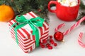 Christmas gift box, red berries and decorations on white table, closeup Royalty Free Stock Photo