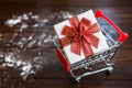 Christmas gift box on shopping cart Royalty Free Stock Photo
